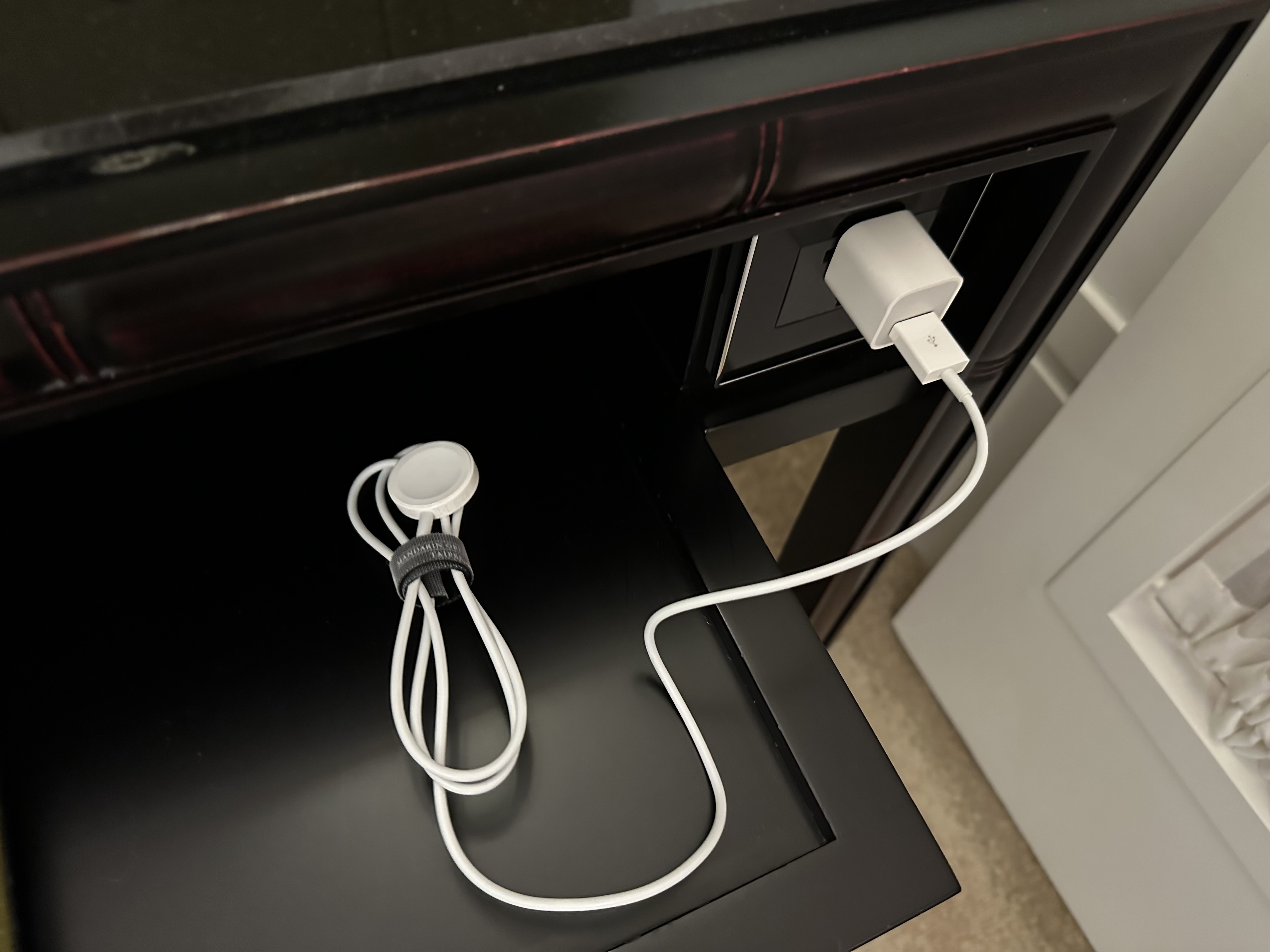 a white cord plugged into a black table