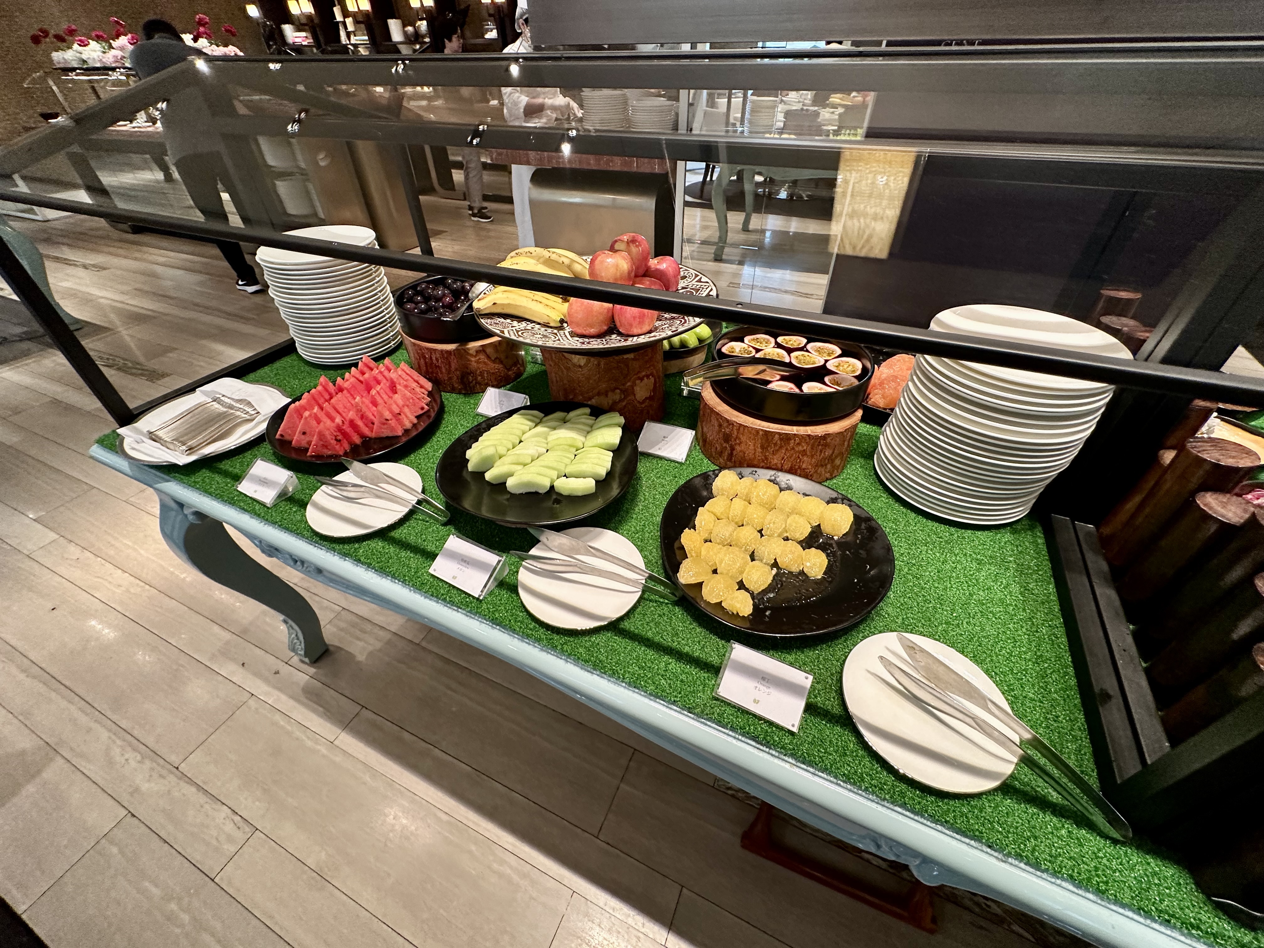 a buffet table with plates and fruits