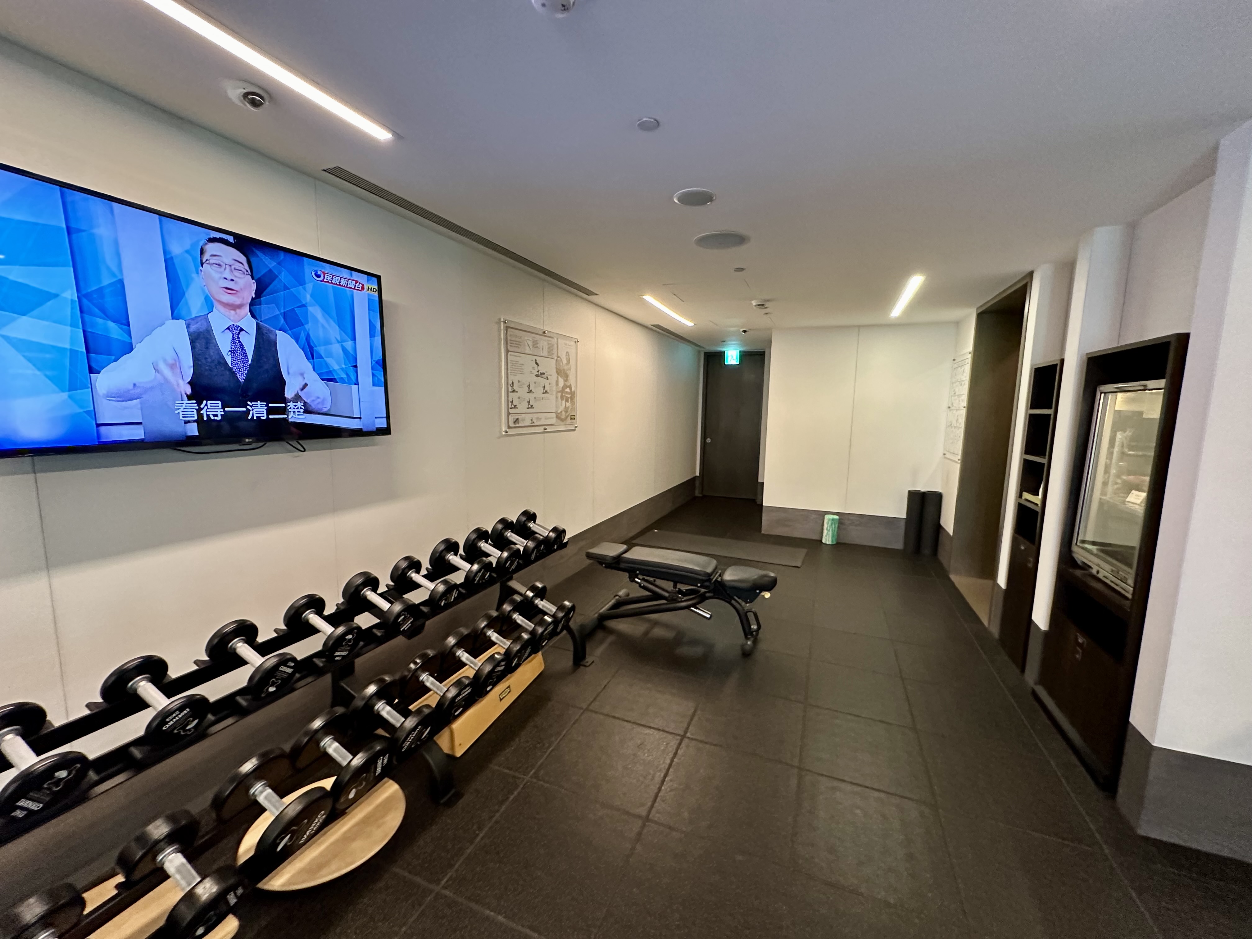 a room with a television and dumbbells