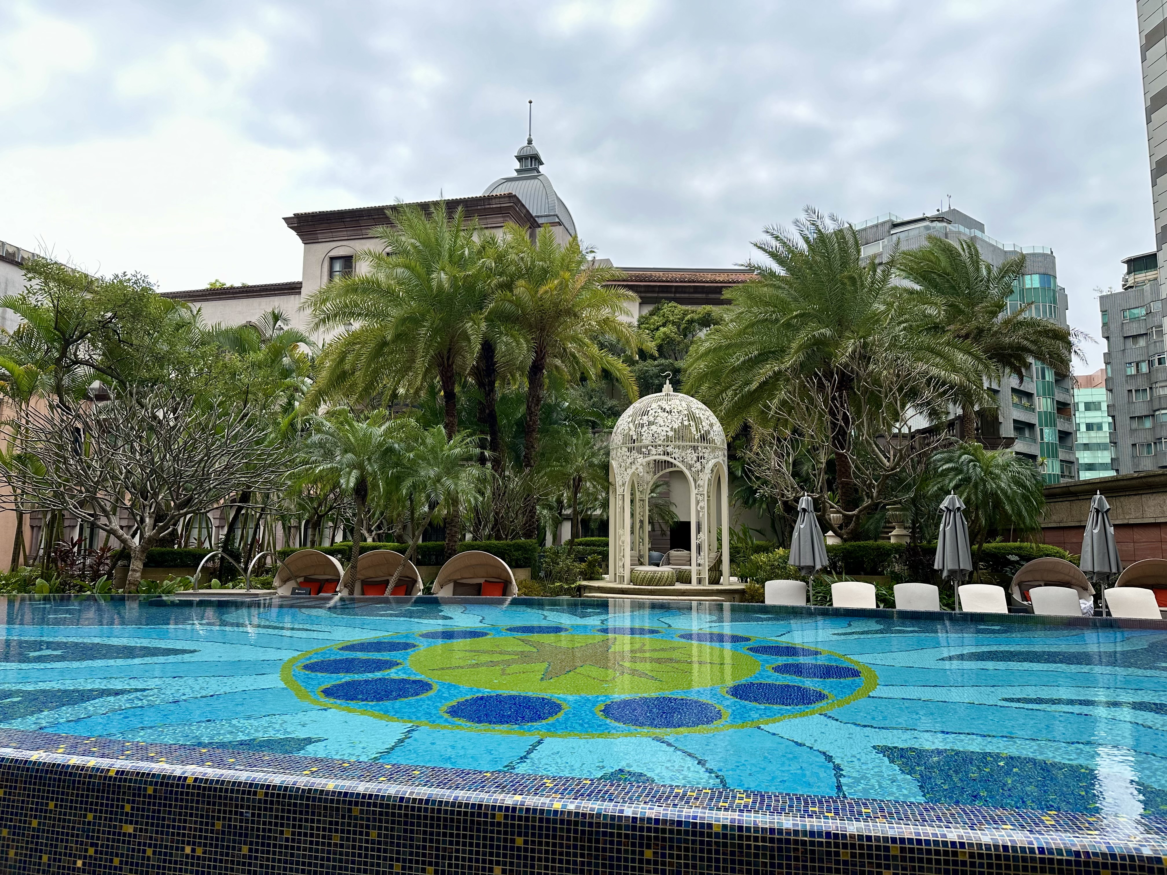 a pool with a gazebo and trees at the Mandarin Oriental Taipei