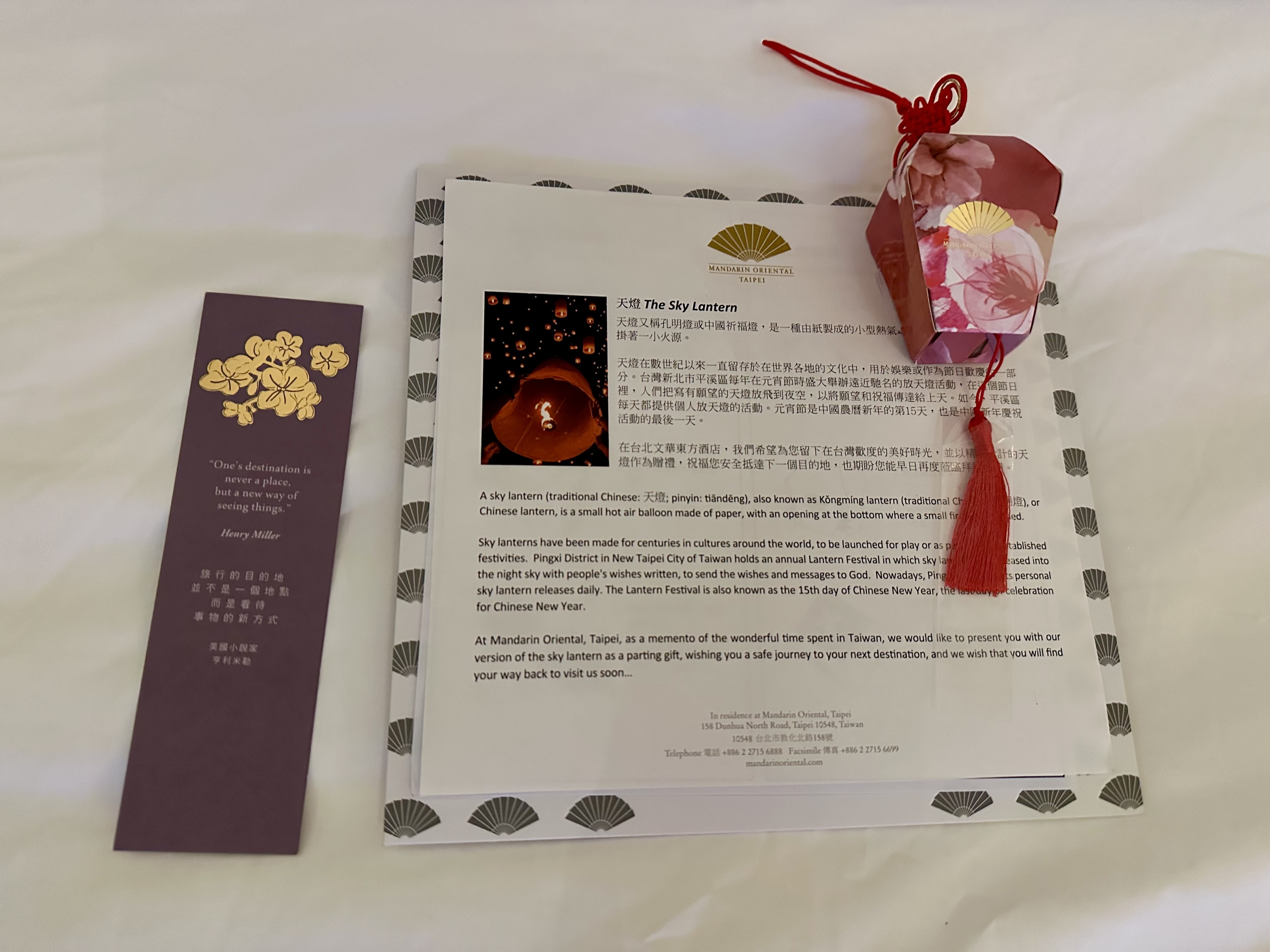 a book and a bookmark on a white surface at the Mandarin Oriental Taipei
