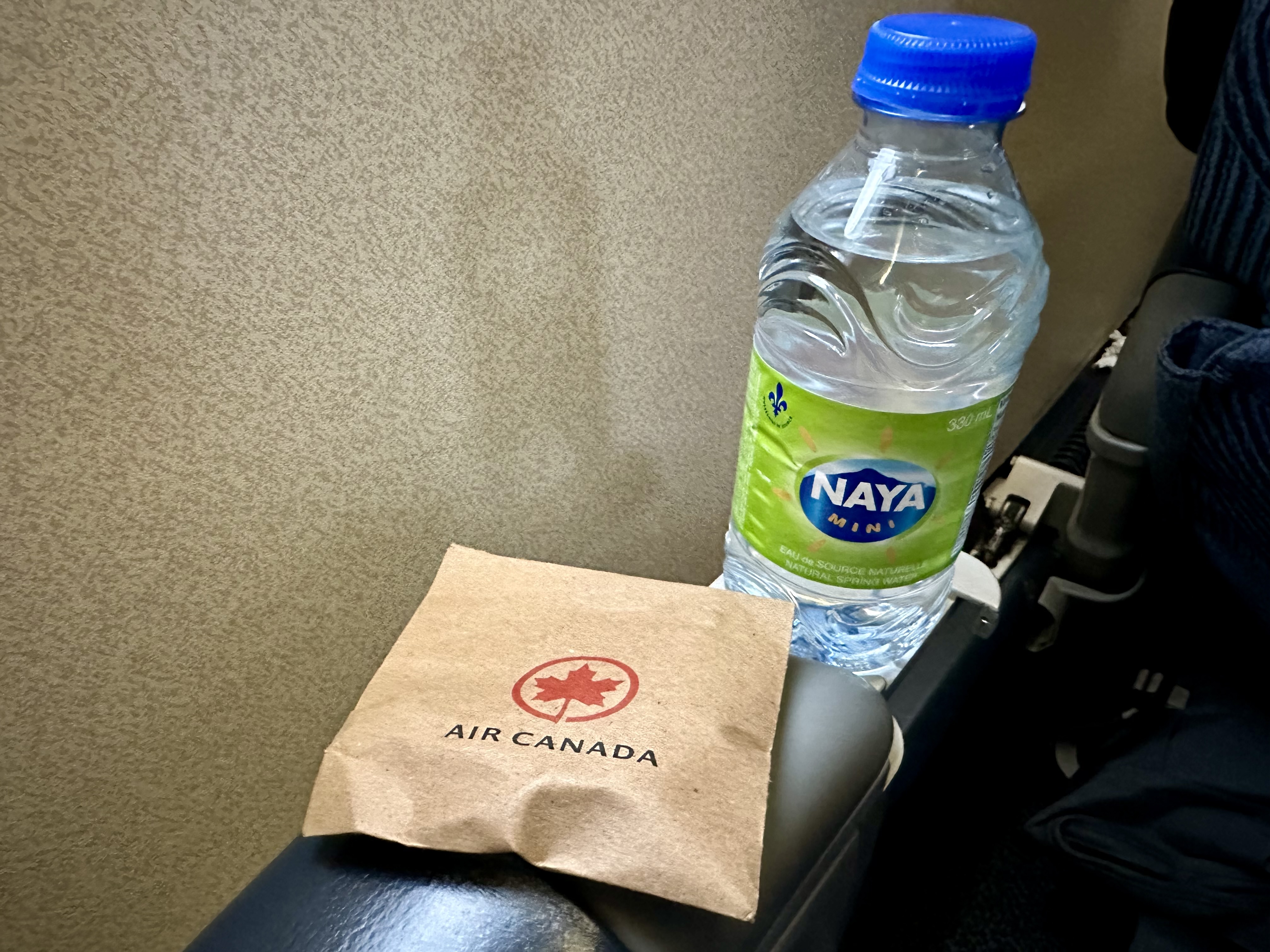 a bottle of water on a arm rest