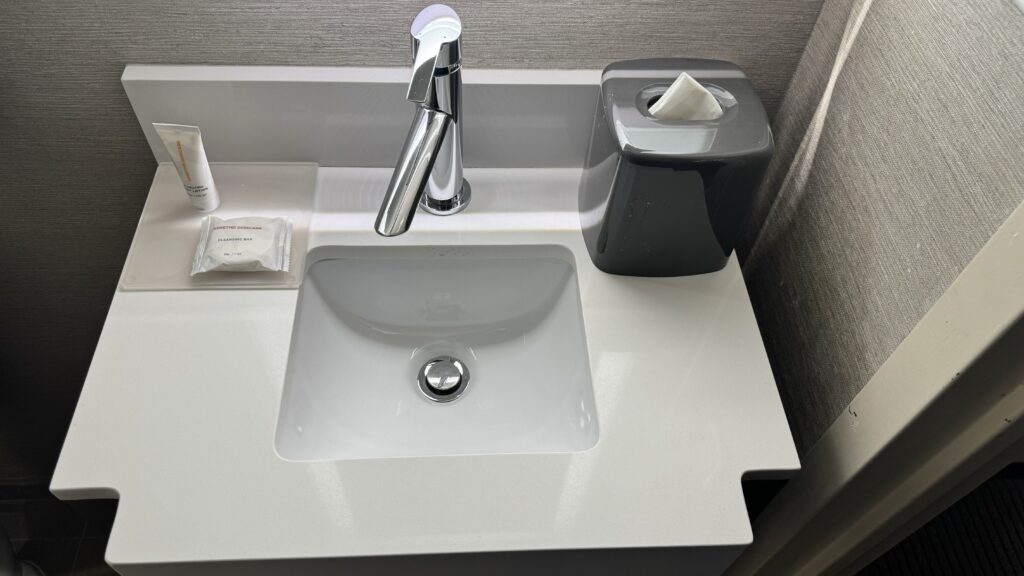 a sink with a tissue box and faucet