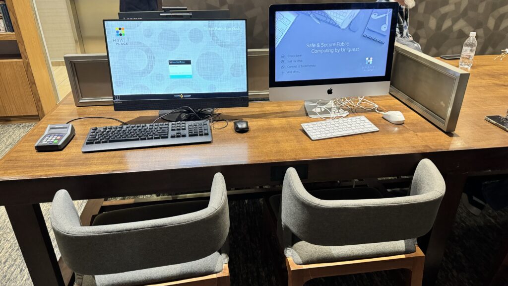 a desk with two computers and a keyboard