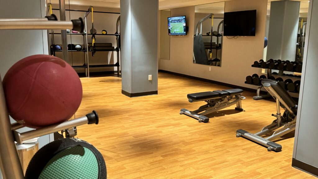 a gym with a television and exercise equipment