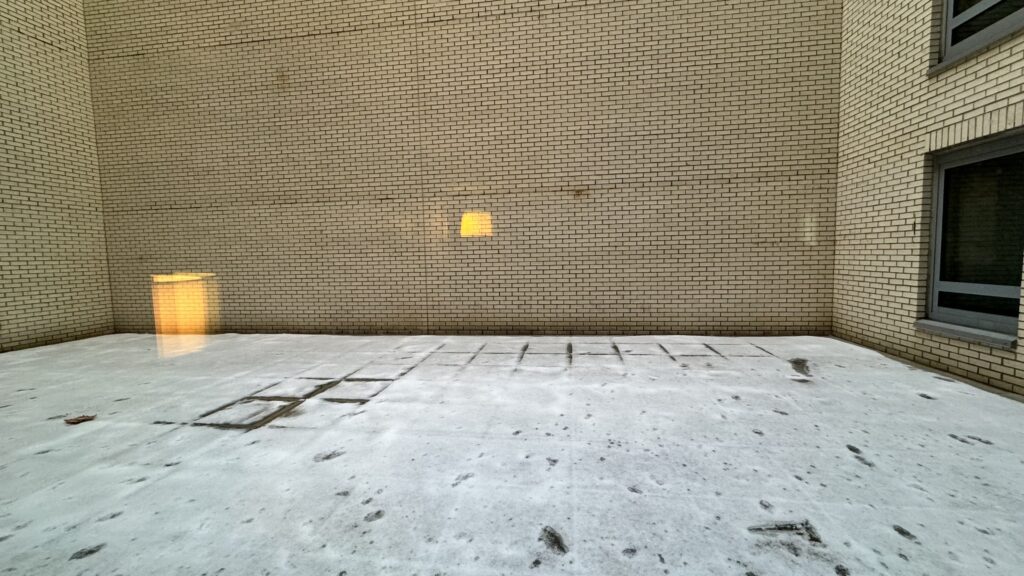 a brick wall with a light in the middle