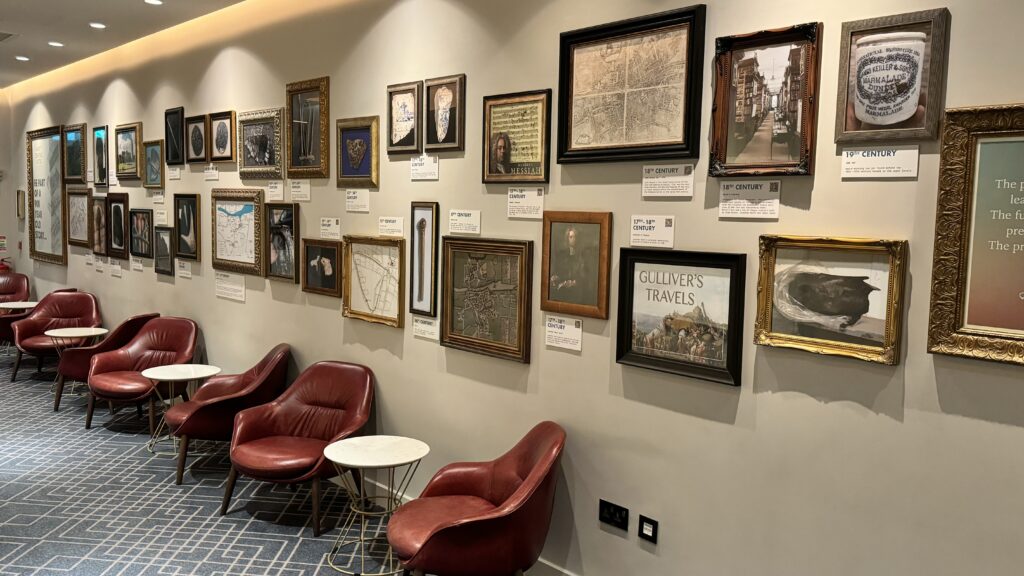 a wall with pictures and chairs