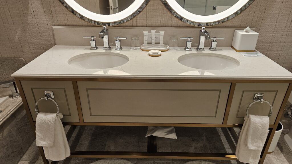 a bathroom sink with two mirrors