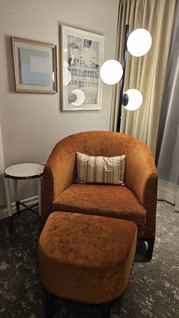 a chair and ottoman in a room