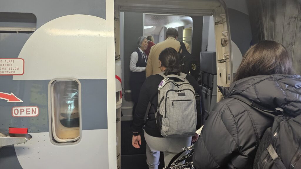 a group of people walking into an airplane