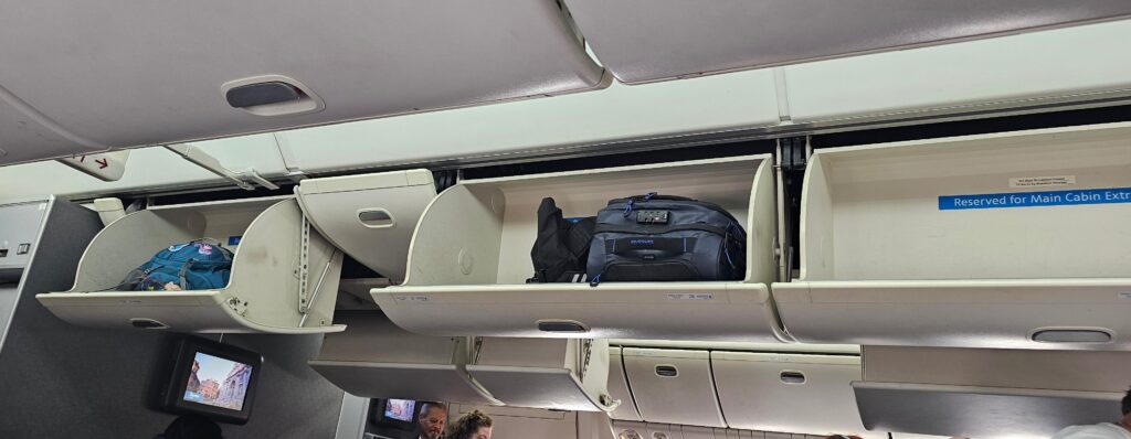 luggage in a shelf on an airplane