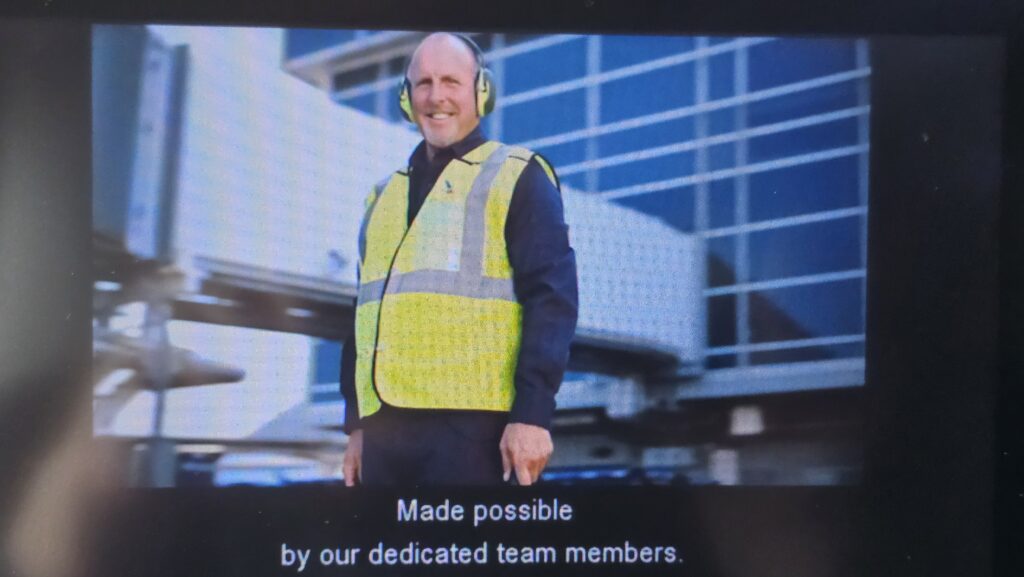 a man wearing a yellow vest and headphones