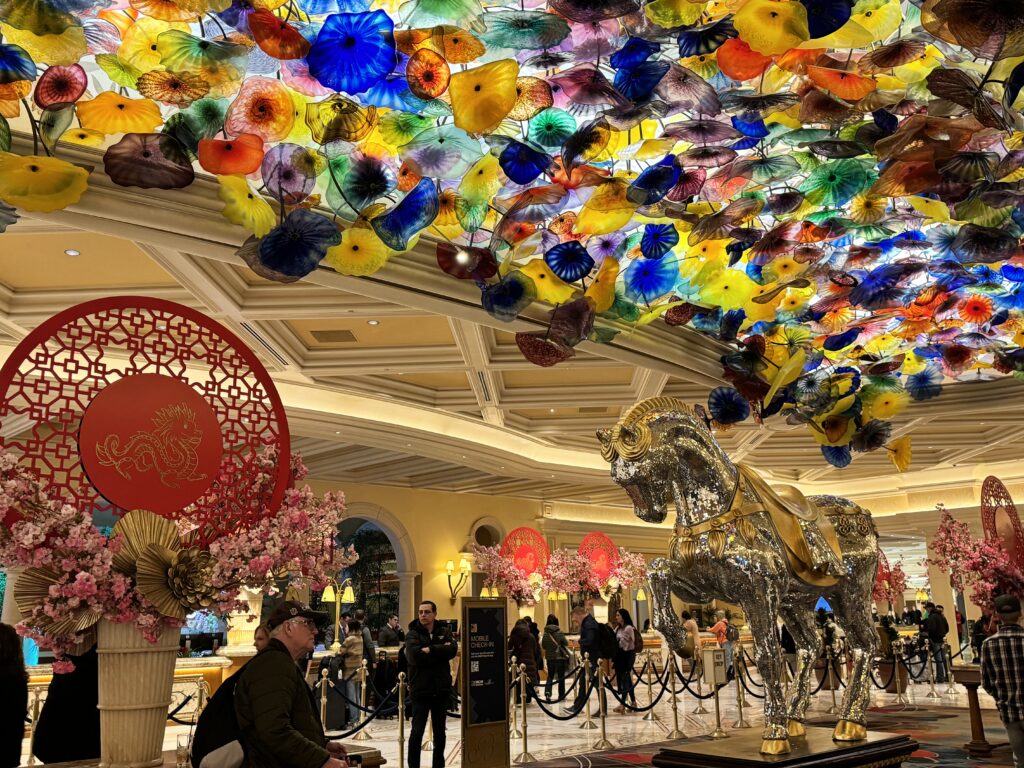 a large room with a large statue of a horse and colorful flowers