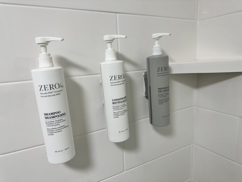 a group of shampoo bottles on a white tile wall