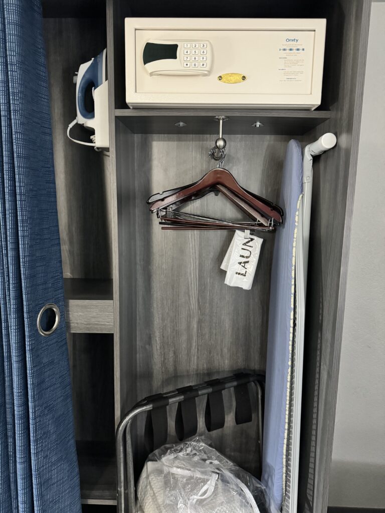 a closet with a white ironing board and a white ironing board