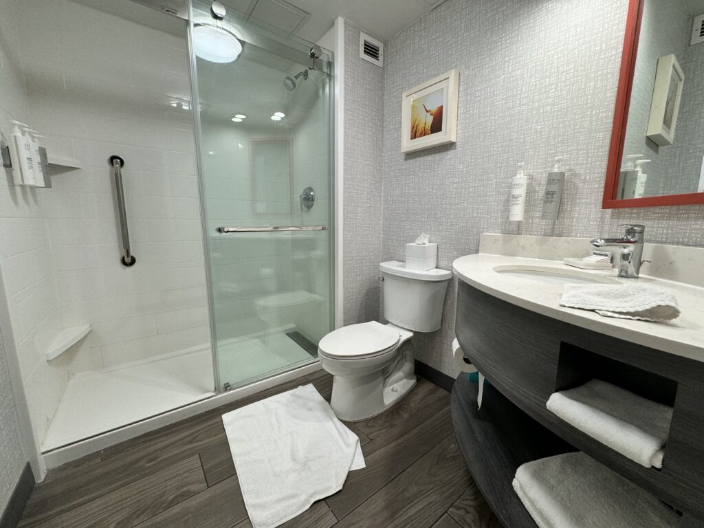 a bathroom with a glass shower and toilet