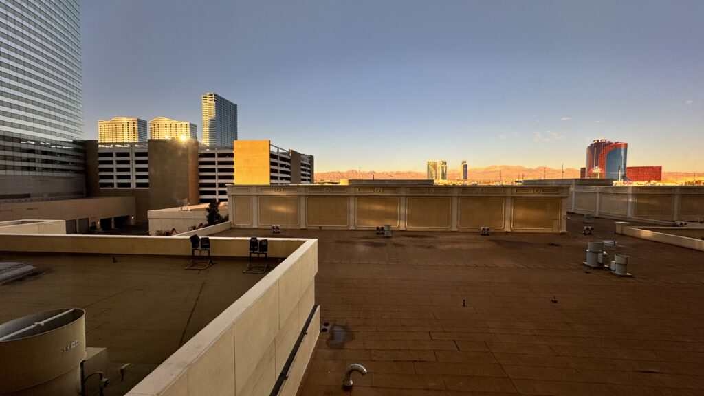 a rooftop with a city skyline in the background