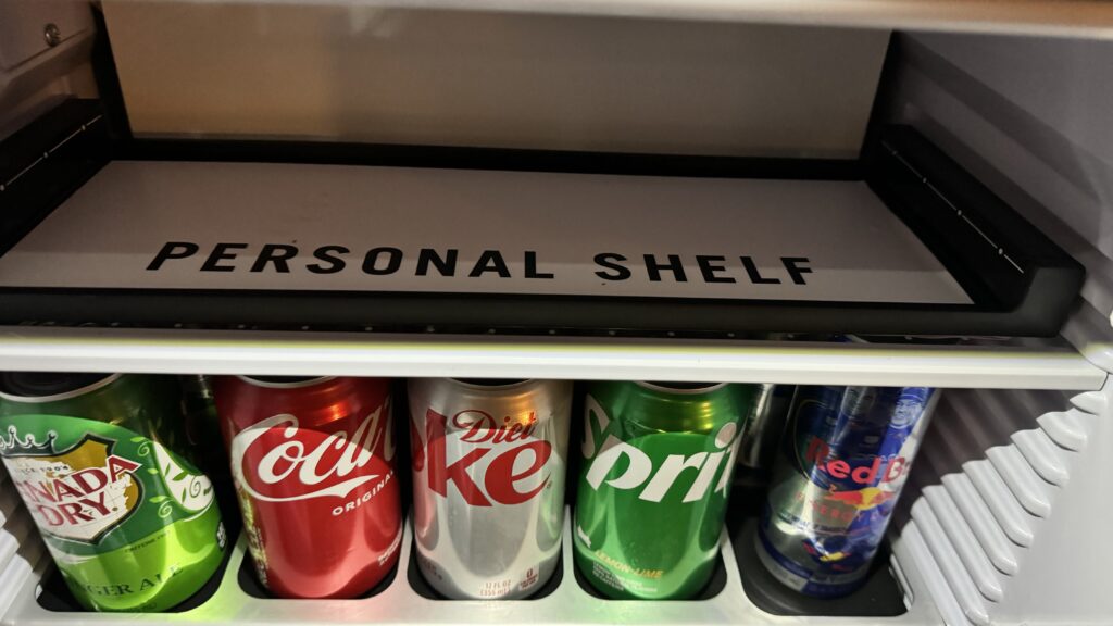 a shelf with cans of soda