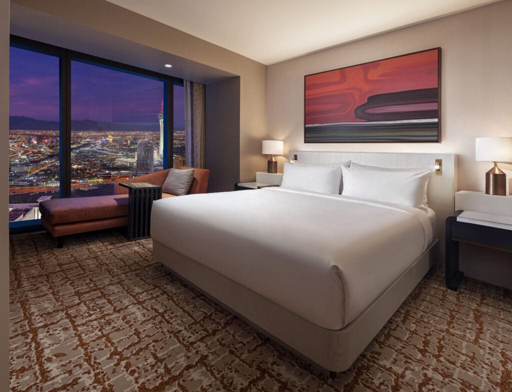 A hotel room with a large bed and a large window at the Las Vegas Hilton at Resorts World