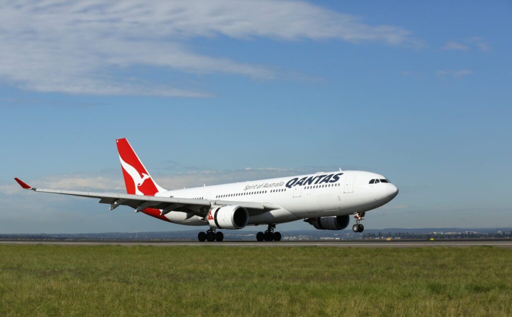 A Qantas Airbus A330 landing on a runway.