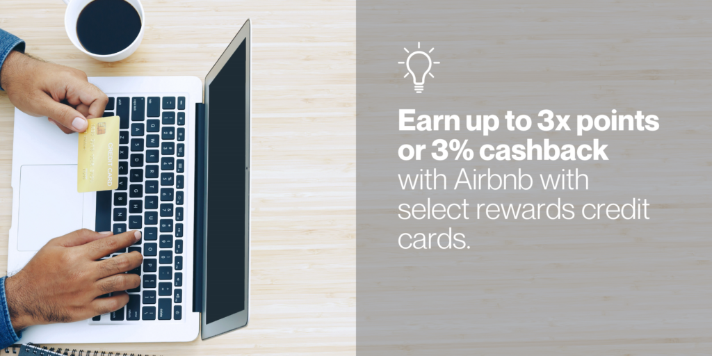 A person sitting at a laptop holding a gold credit card with text to the right of the image reading, "Earn up to 3x points or 3% cashback with Airbnb with select rewards credit cards."