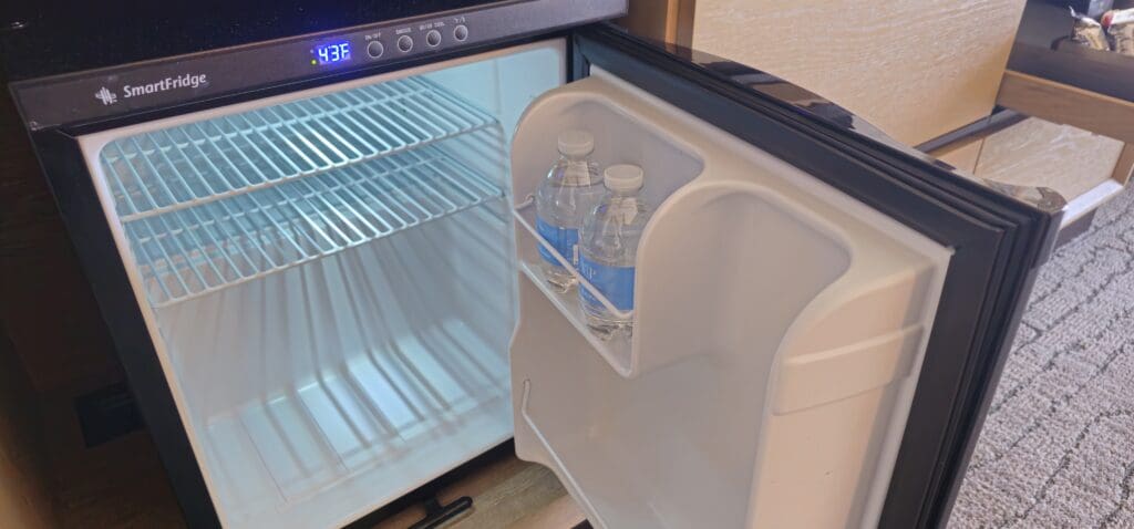 a refrigerator with bottles of water inside