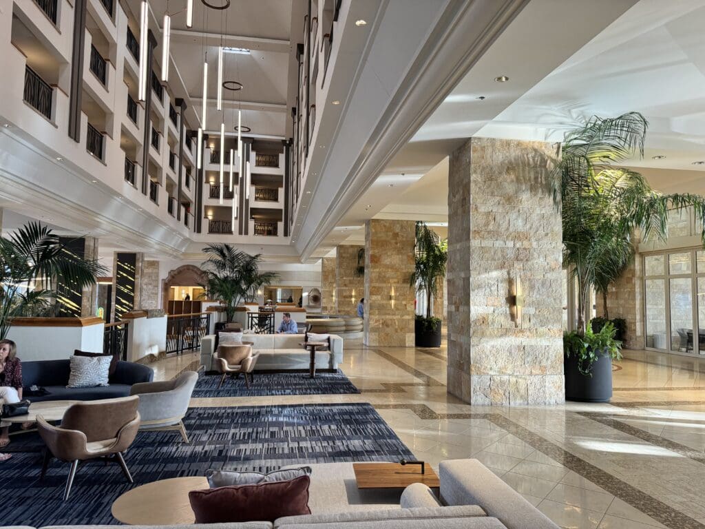 a large lobby with a large stone wall and a large stone column