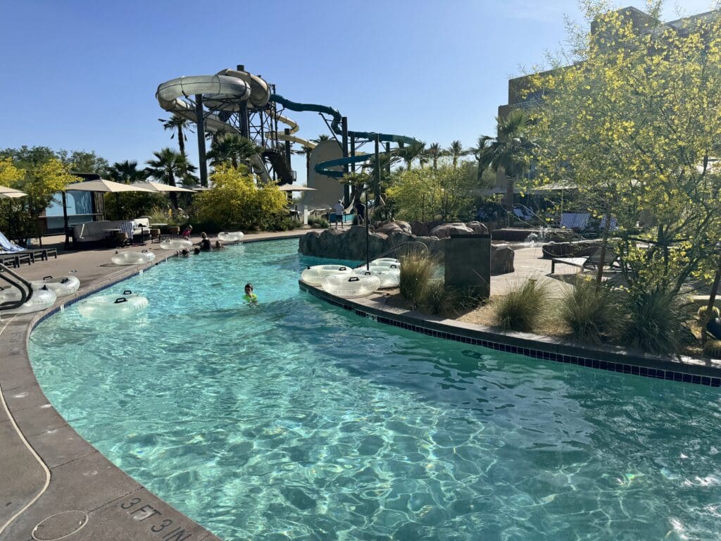 a pool with water slides and people in it