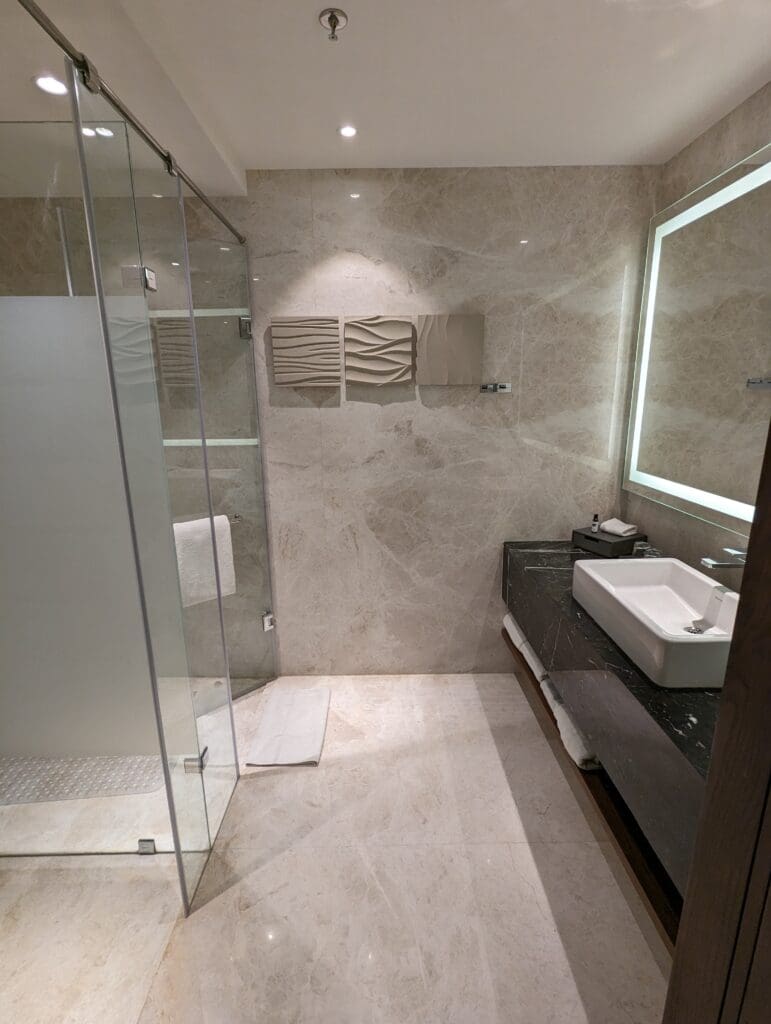 a bathroom with a glass shower and sink