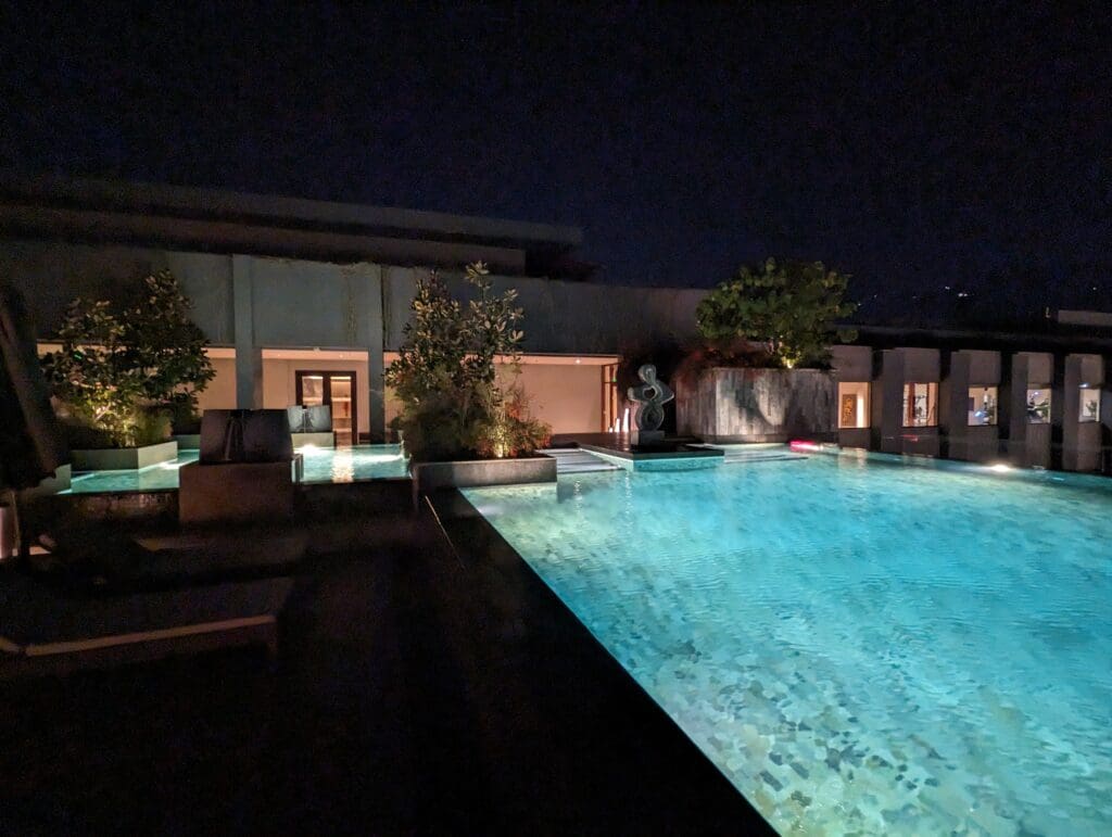 a pool with a statue in the middle of it