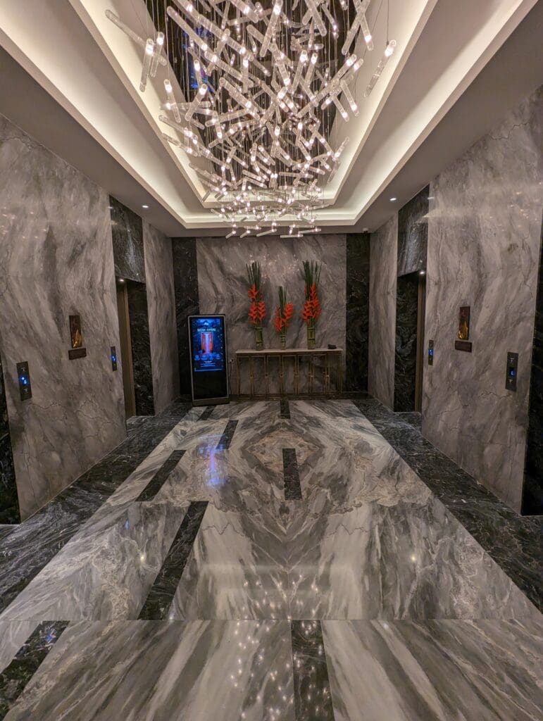 a marble floor with a chandelier and flowers