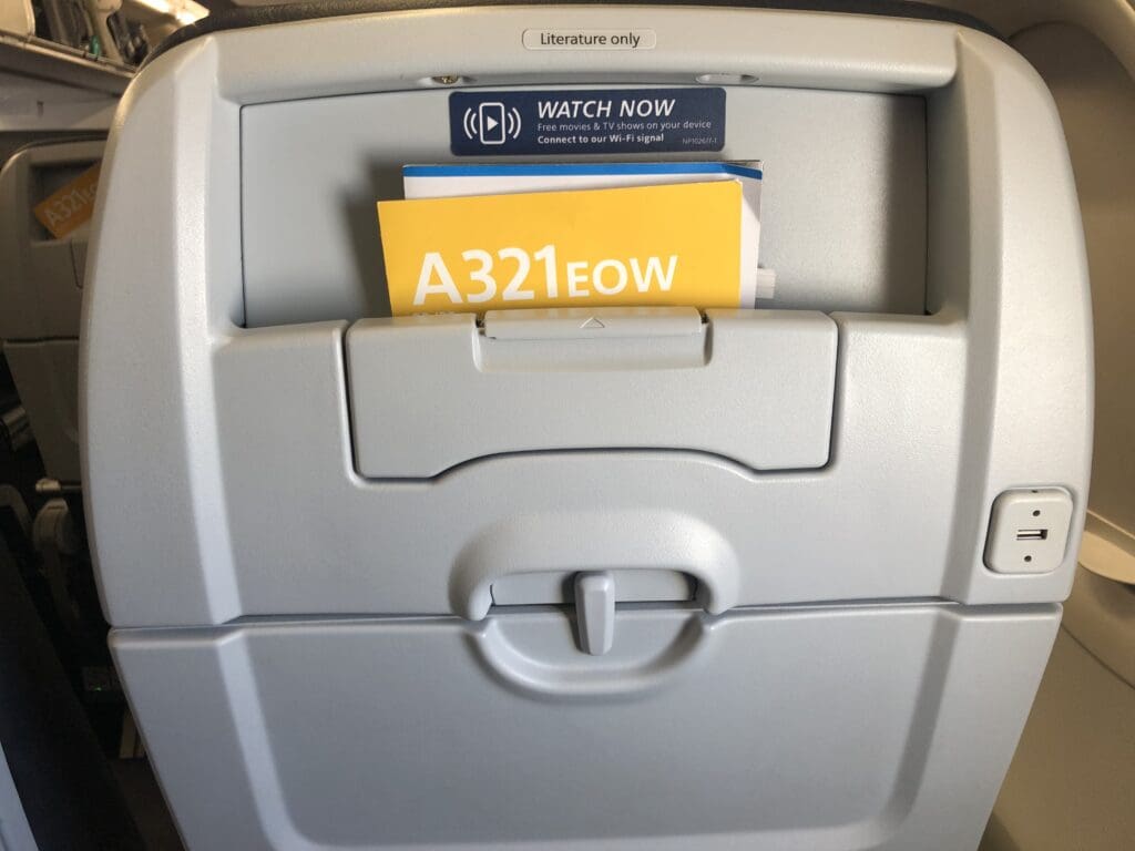 a grey plastic container with a yellow and blue sign inside