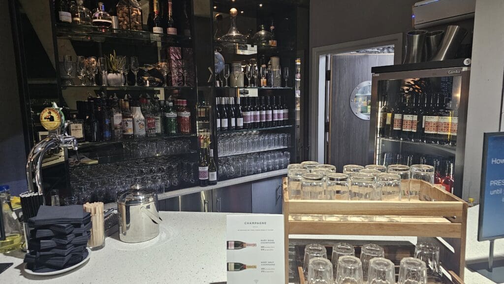 a shelf with wine glasses and bottles