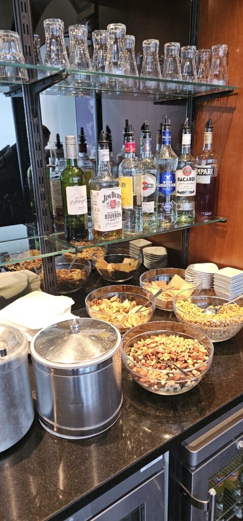 a shelf with bottles of alcohol and snacks