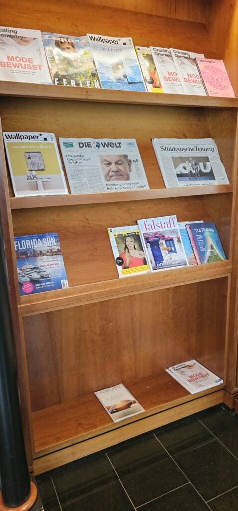 a wooden shelf with several magazines