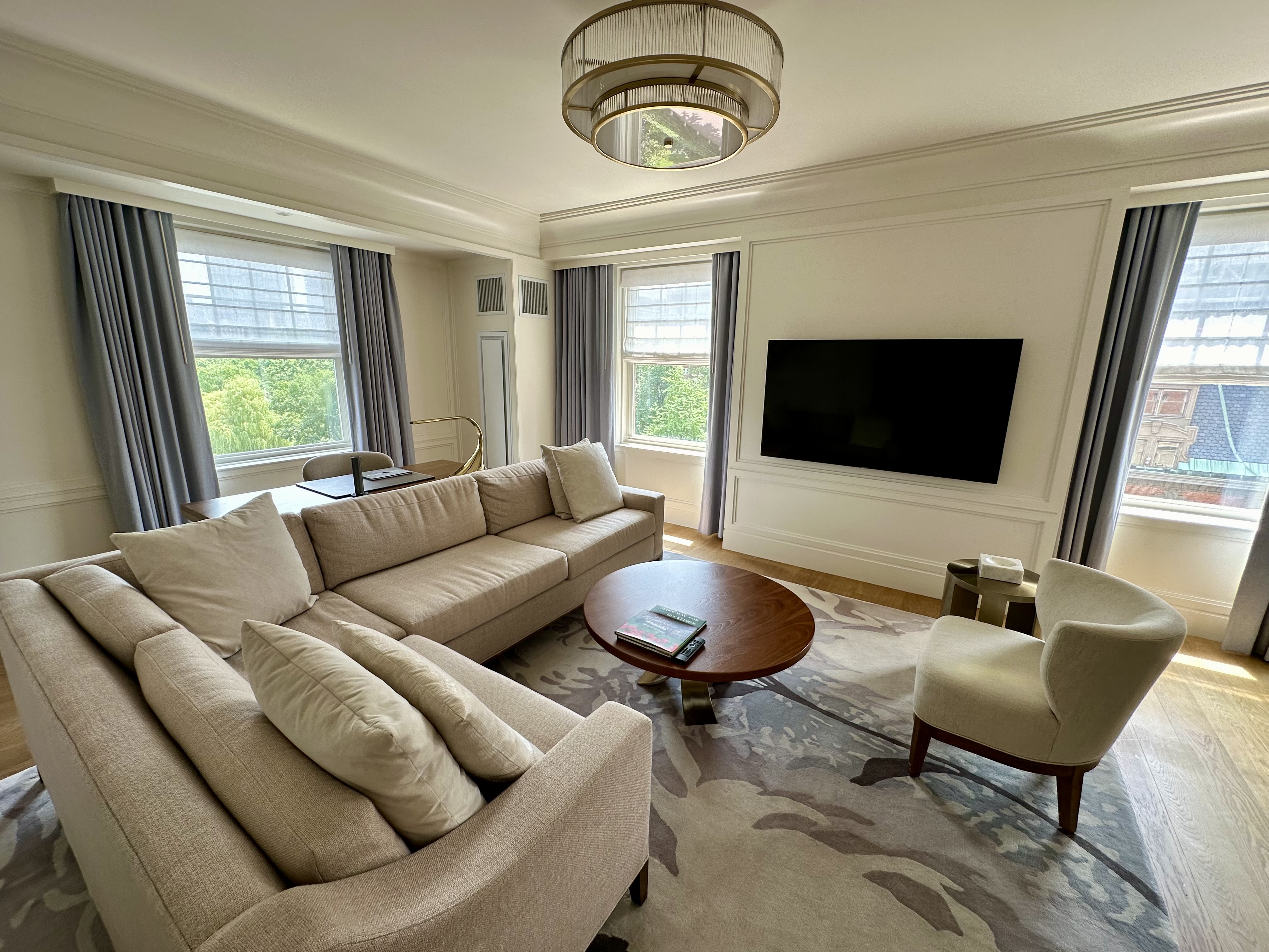 a living room with a couch and a tv at the Newbury Boston