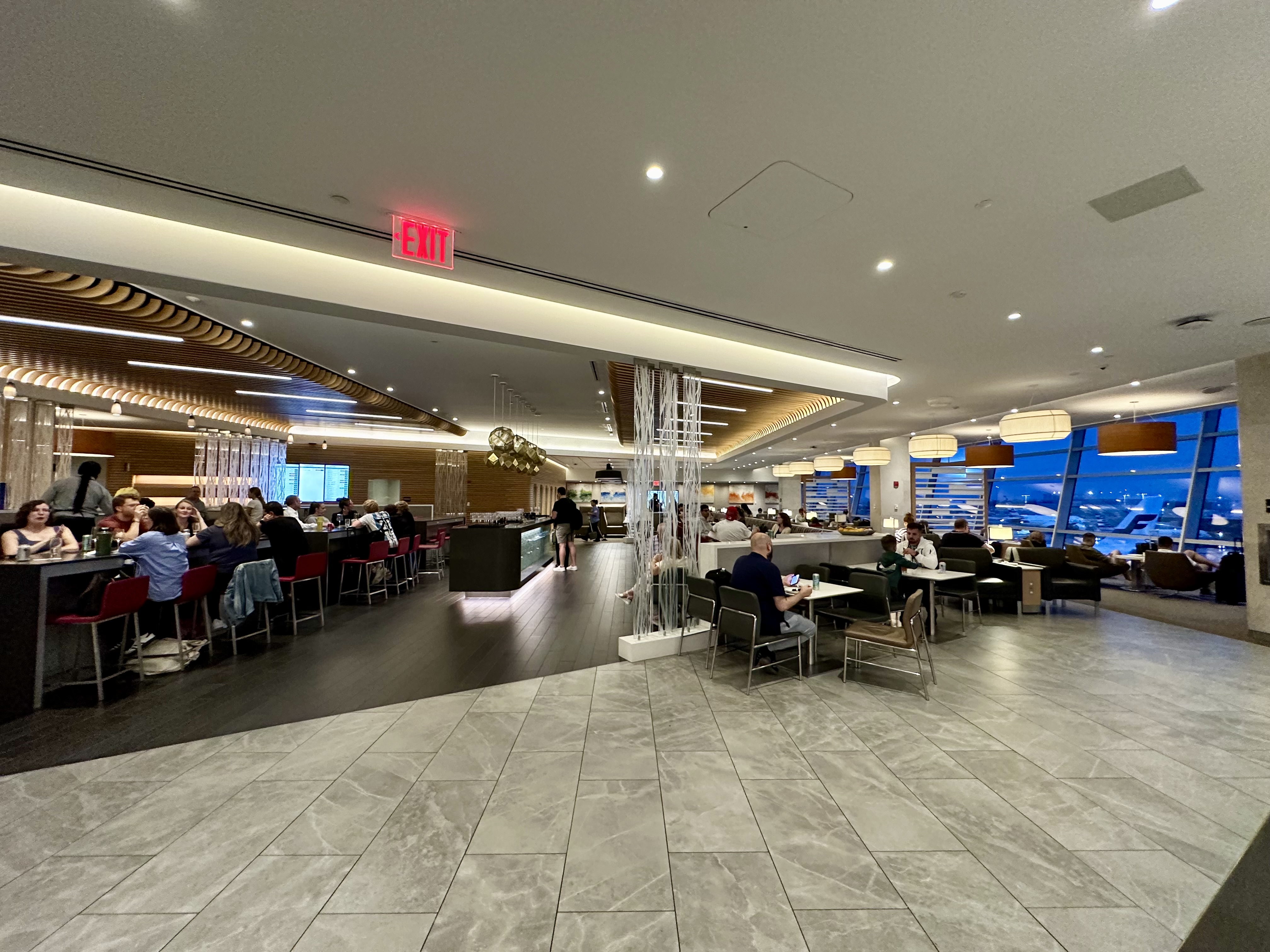 a room with people sitting at tables and chairs