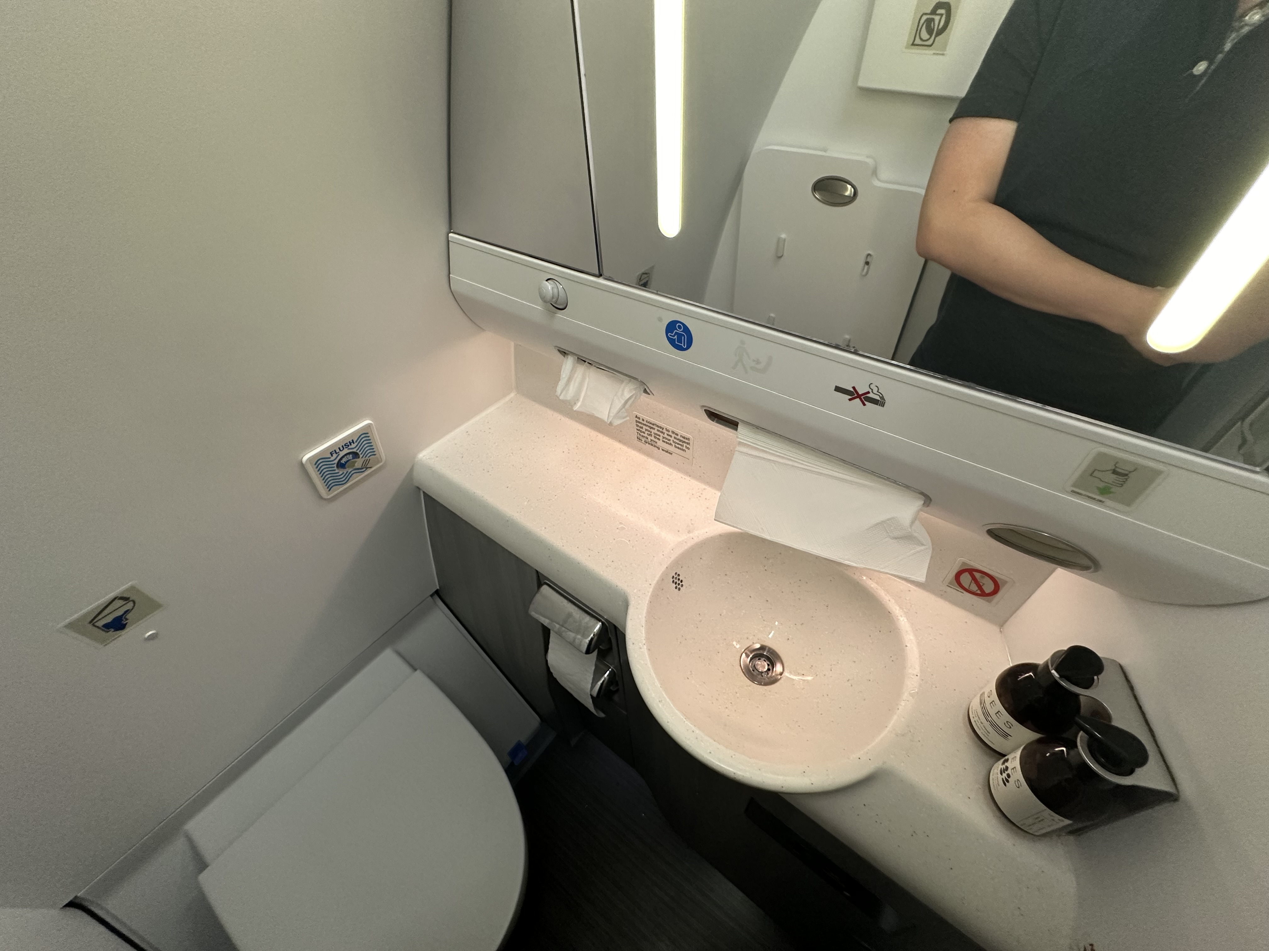 a mirror of a bathroom with a sink and toilet