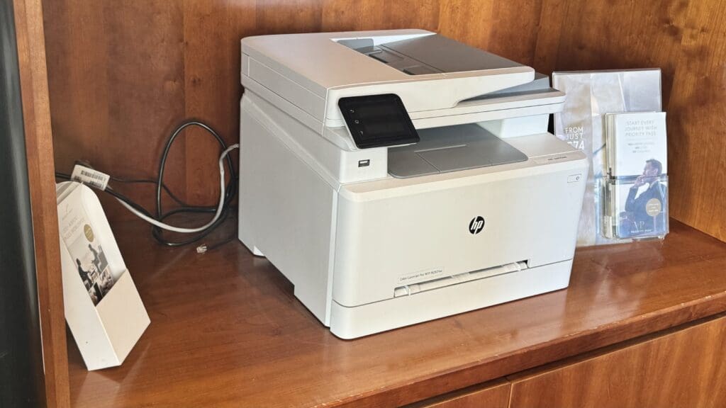 a white printer on a wood surface