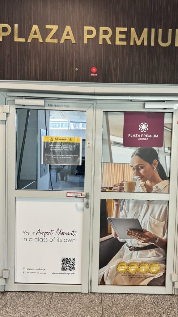 a glass door with a woman holding a tablet