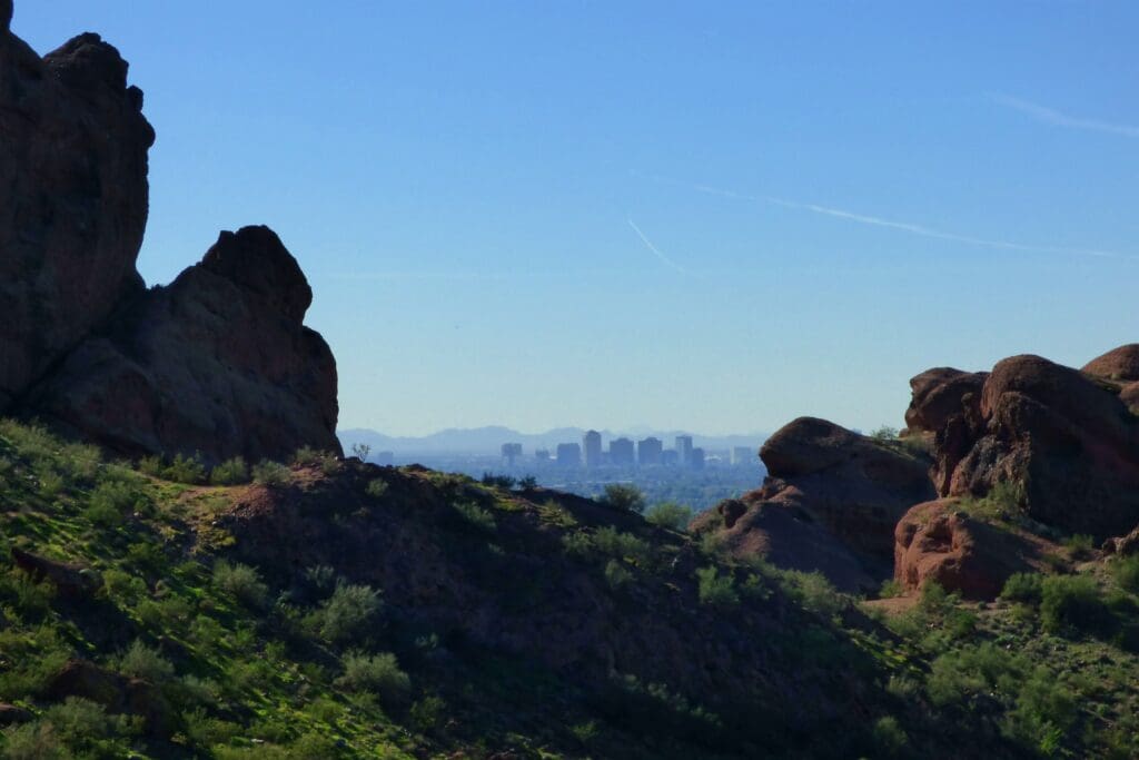 a rocky hills with a city in the background