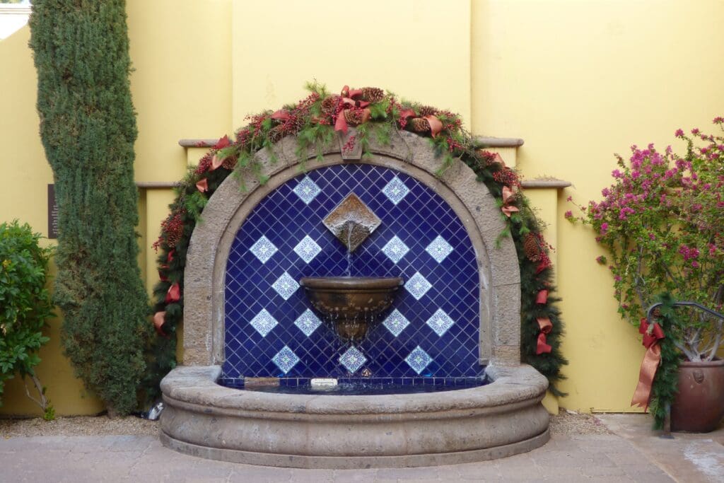 a fountain with a blue and white tile wall