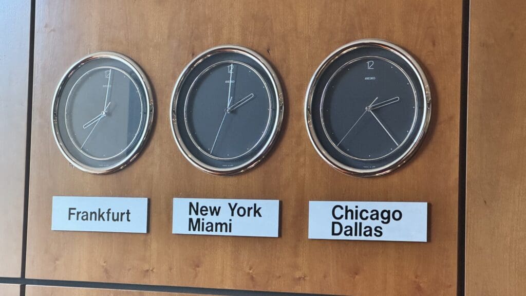 clocks on a wall with signs