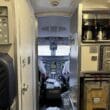 inside an airplane cockpit with a door open