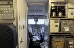 inside an airplane cockpit with a door open