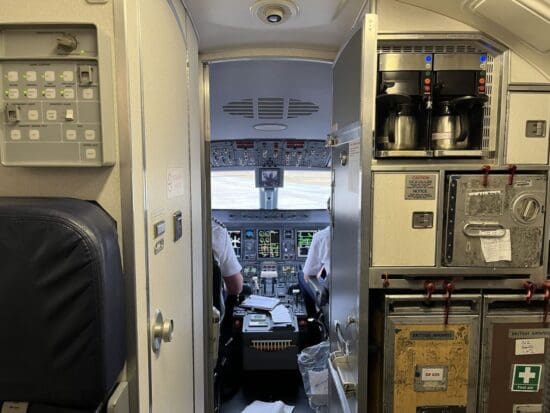 inside an airplane cockpit with a door open