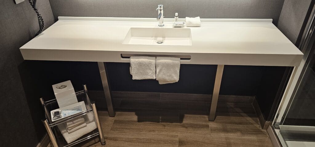 a white sink with two towels on it