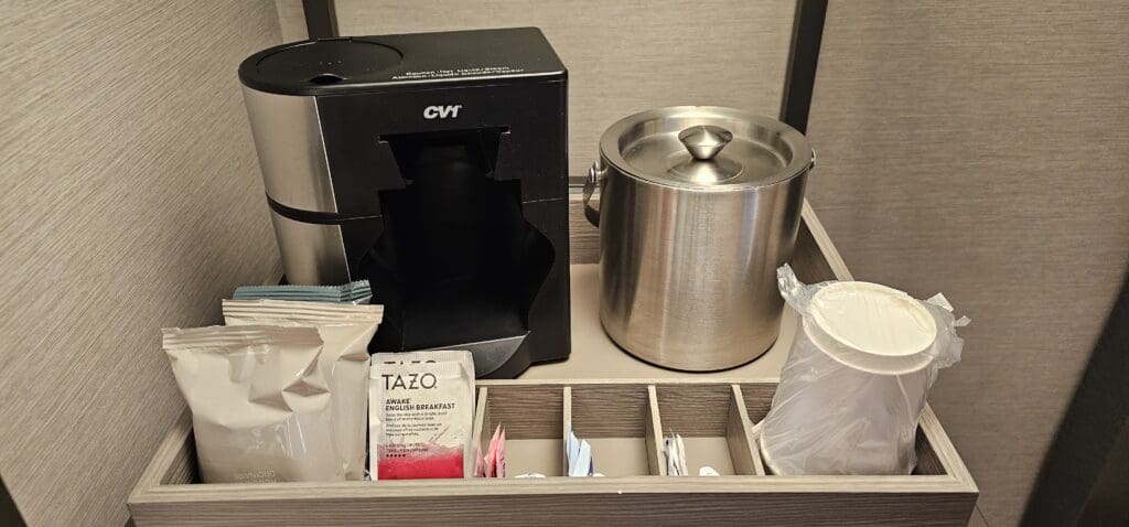 a coffee maker and tea bags in a drawer