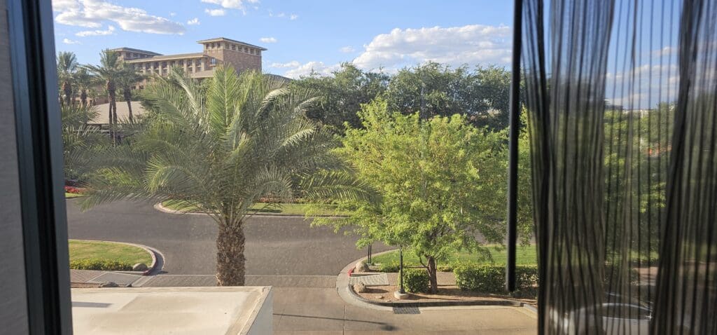 a street with trees and a building in the background