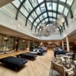 a room with a large glass ceiling and a large chandelier